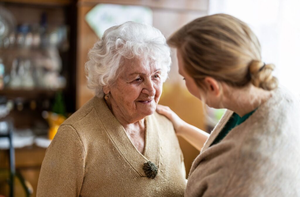 Healthcare aide checking in on a female resident.