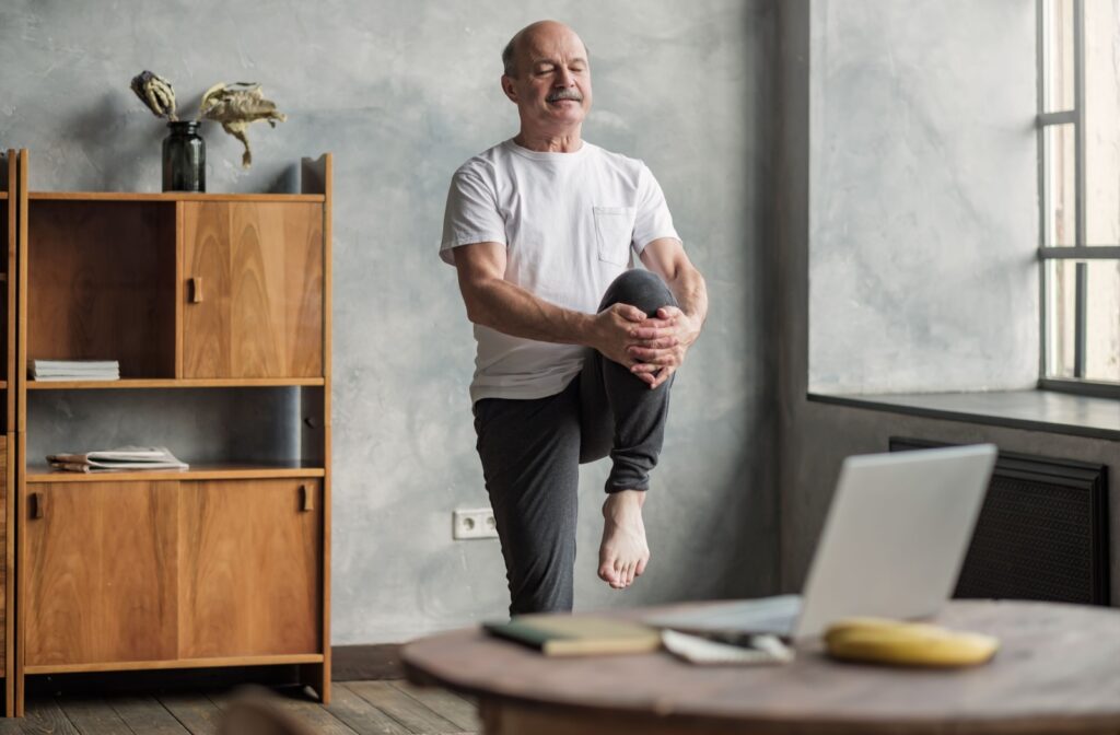 A senior performs gentle leg and hip stretching to help relieve arthritis pain.