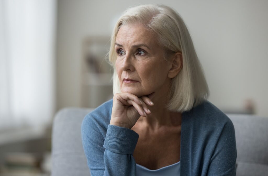 Senior woman struggling with activities of daily living due to the effects of dementia.