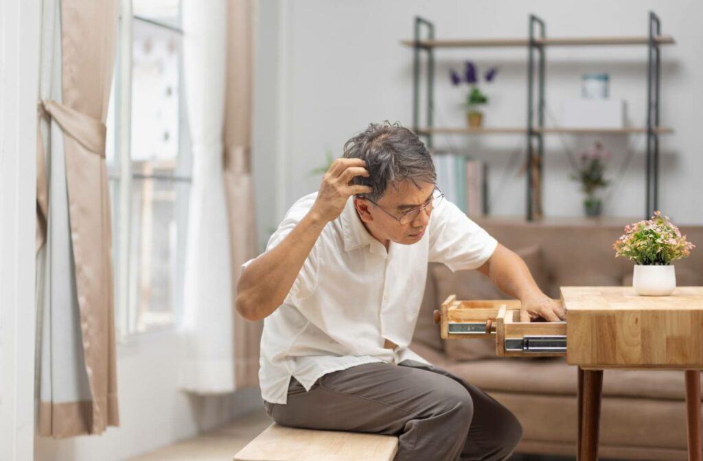 older man finding something that he forgot it in drawers.
